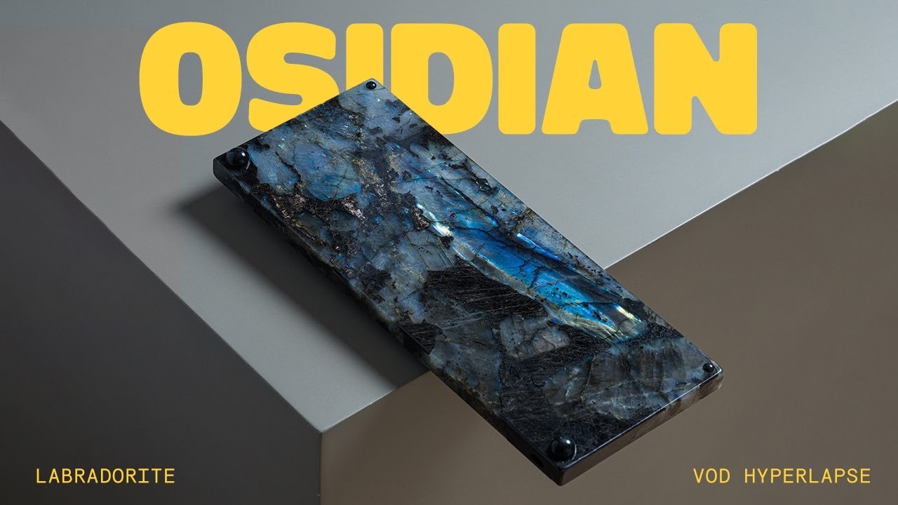 YouTube post by @alexotos for Unikeyboards. Caption reads: A Keyboard Made Of Stone (it's good).