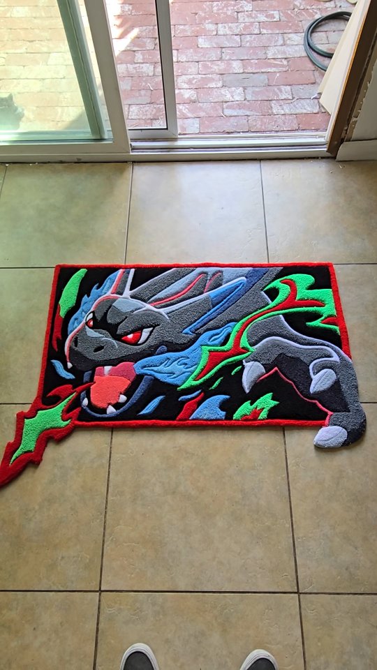 Instagram post by @abnormal.customs for Whatnot. Caption reads: I turned Mega Charizard X into a custom rug 🔥....
