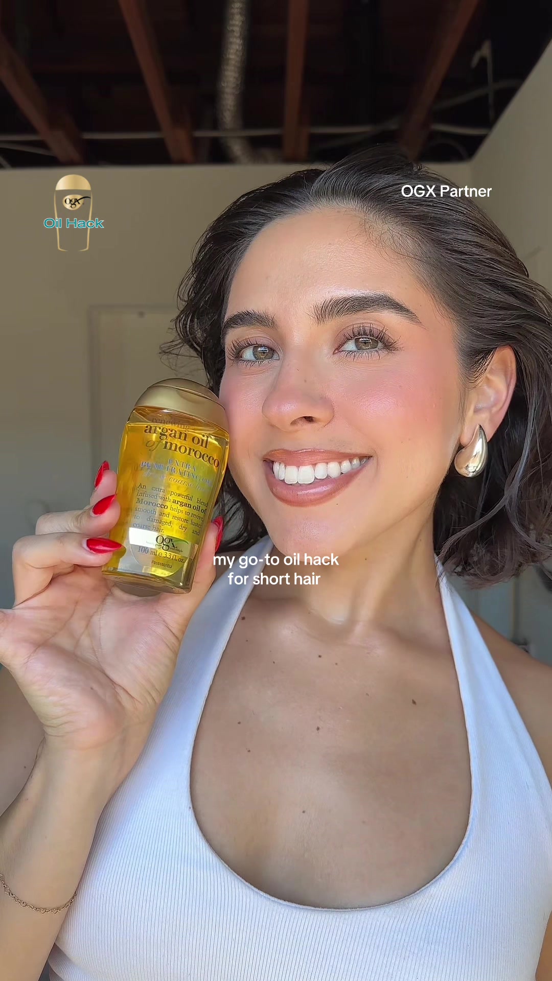 TikTok post by @elizabethandreaa_ for OGX Beauty. Caption reads: #OGXPartner from sleek styles to effortless....