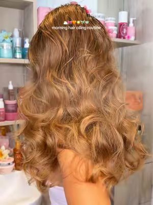 TikTok post by @by.emmaleah for Emi Jay. Caption reads: [...] oiling routine ⛅️🎀🧡🌟🧚🏼🍵 products @Emi....