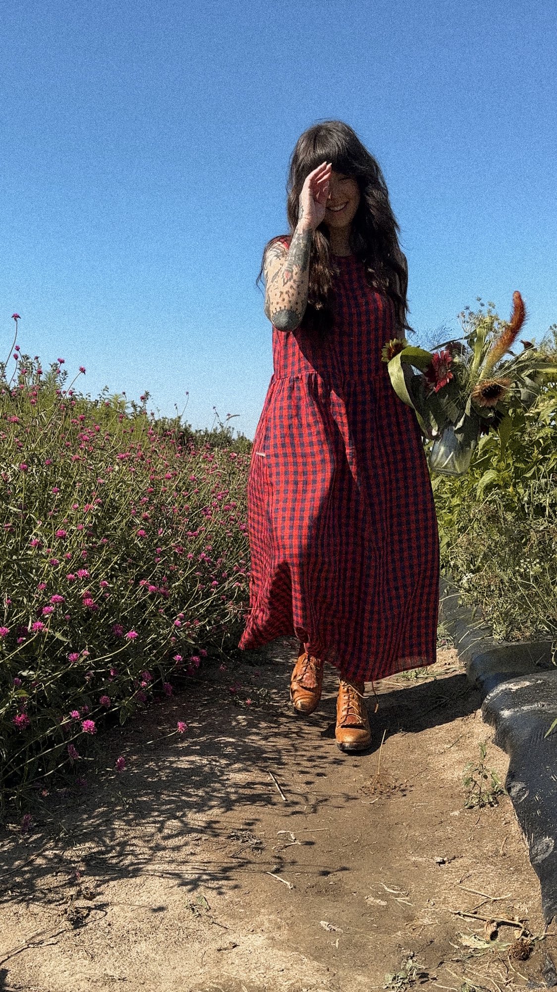 Instagram post by @thegoodrichwife for Tradlands. Caption reads: Late summer feelings 🌻🦋
Went flower picking with....