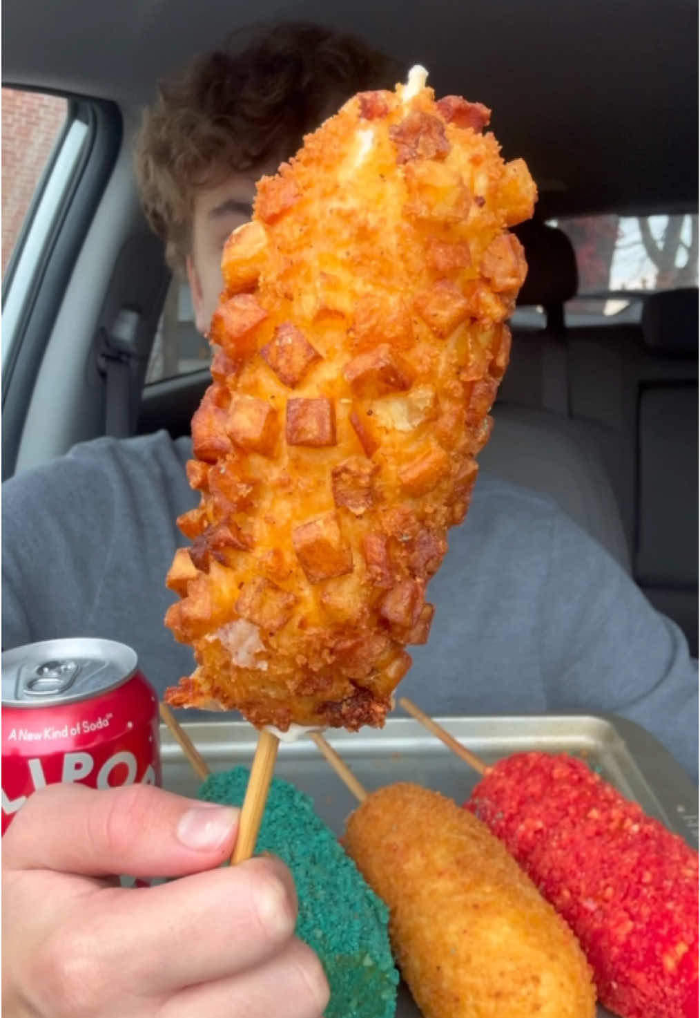 TikTok post by @derekeatsss for OLIPOP. Caption reads: Korean corn dogs 😋 @OLIPOP #olipoppartner....