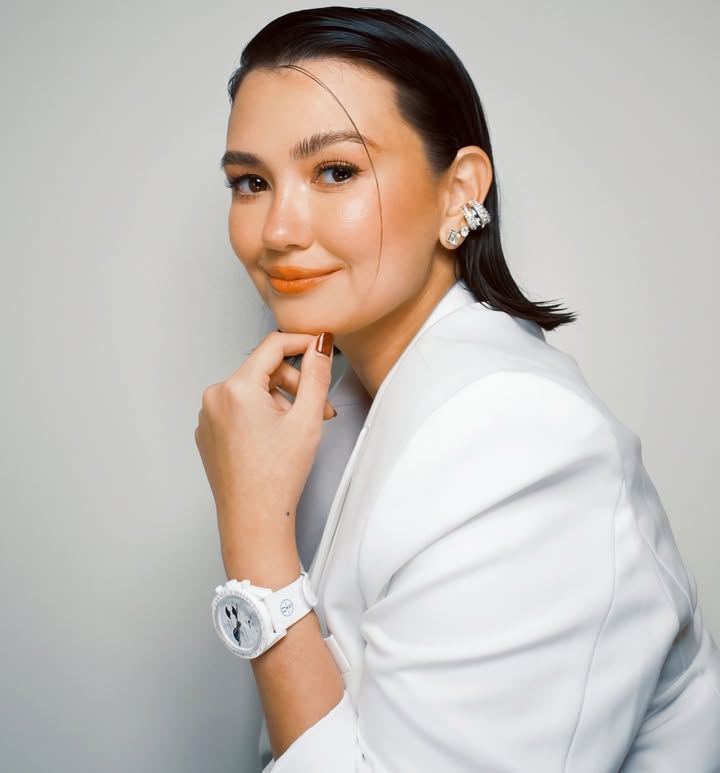 Instagram post by @iamangelicap for Swatch. Caption reads: [...] Not me… the watch 😉 

Available in....