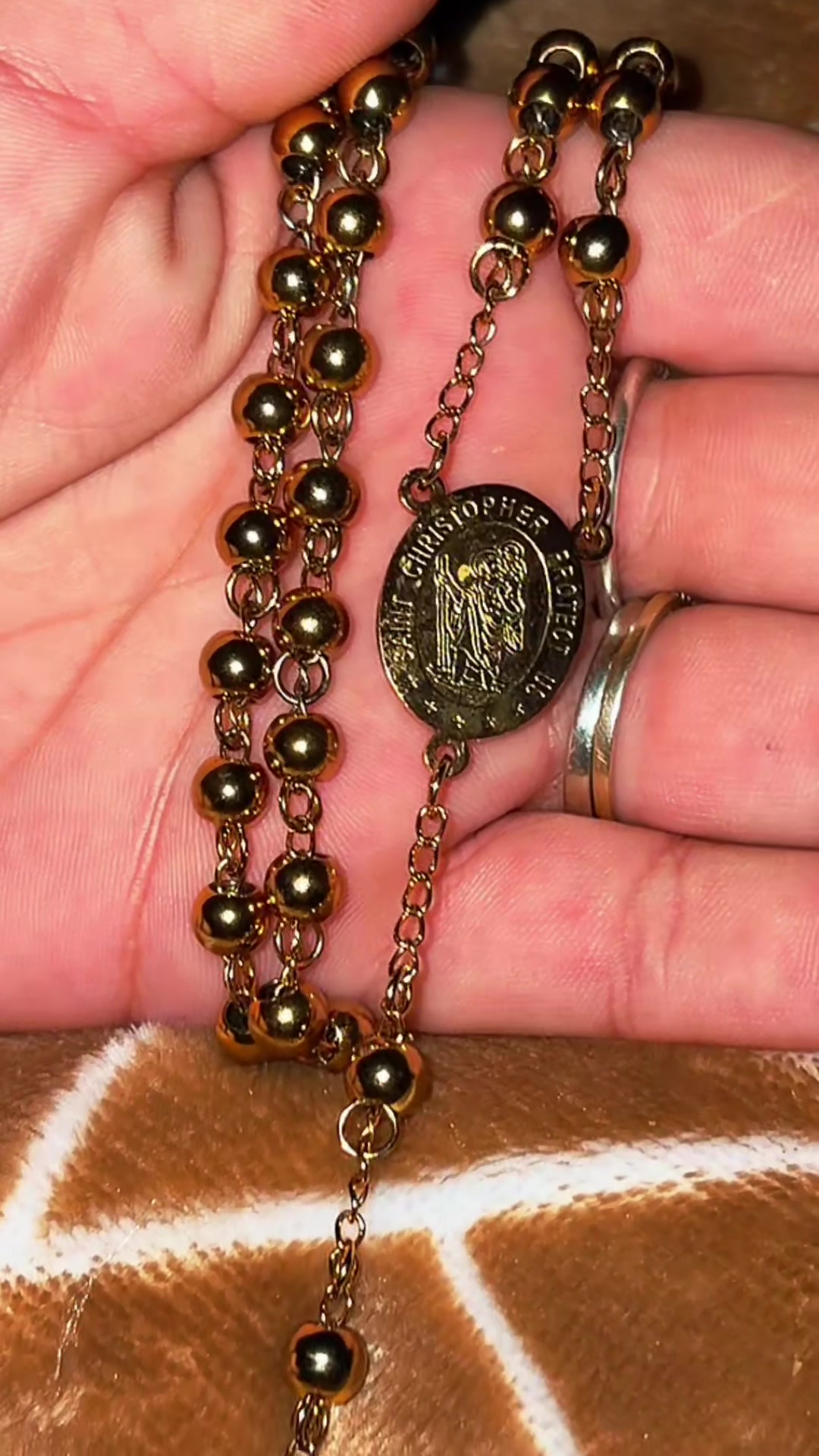 TikTok post by @kimtate8 for FaithHeart Jewelry. Caption reads: @FaithHeart Jewellery Golden Rosary ✨ Pray with....