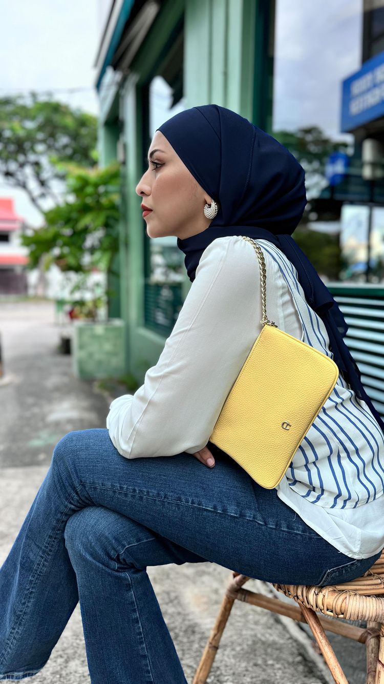 Instagram post by @aanurul for Etienne Aigner AG. Caption reads: Here’s a timeless Aigner Pouch that adds a touch....