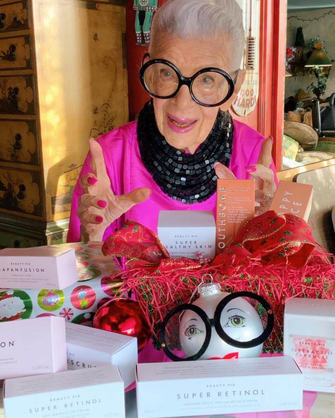 Instagram post by @iris.apfel for BEAUTY PIE. Caption reads: As far as I’m concerned, I’m the Youthbomb in this....