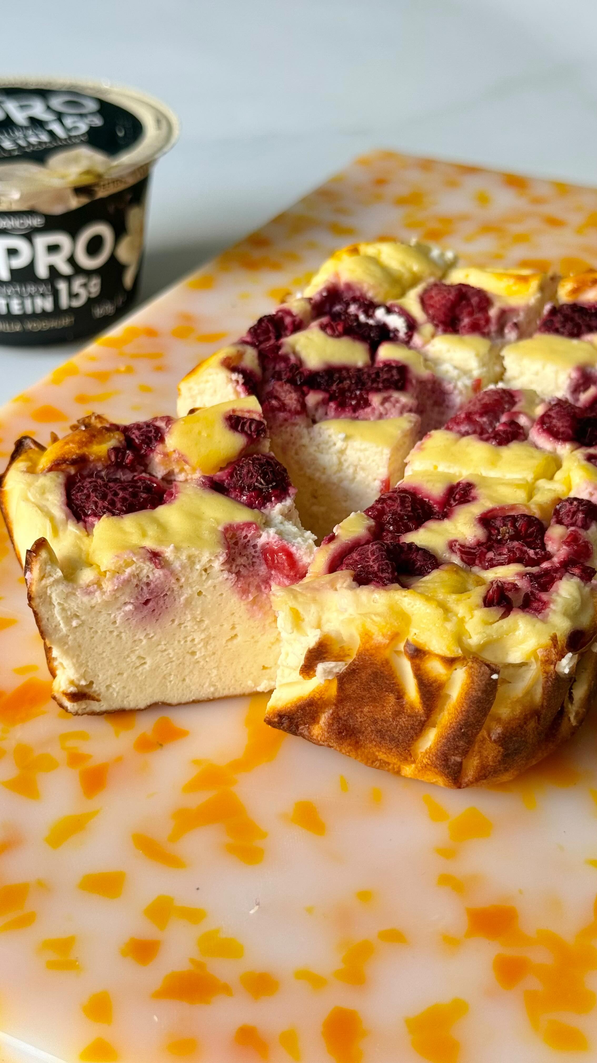 Instagram post by @chenoahill for YoPRO. Caption reads: high protein raspberry cheesecake....