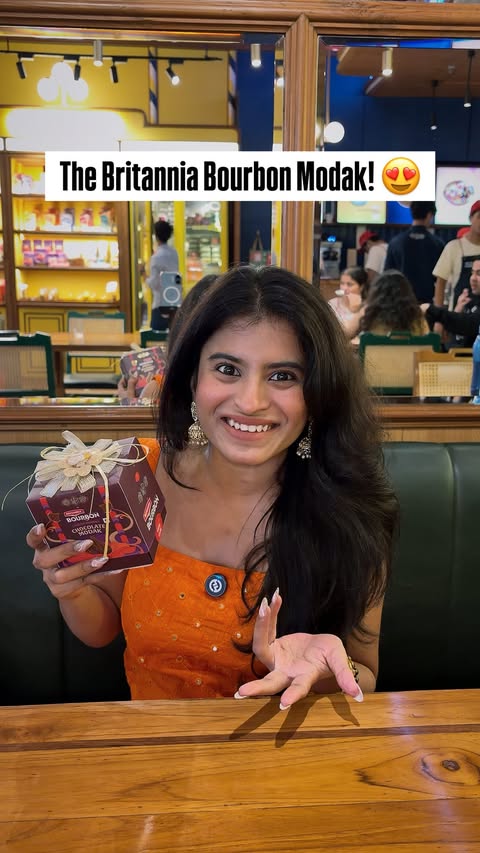 Instagram post by @born_to_be_curious for Britannia SnackInc. Caption reads: I was waiting in line at Lalbaugcha Raja when I....