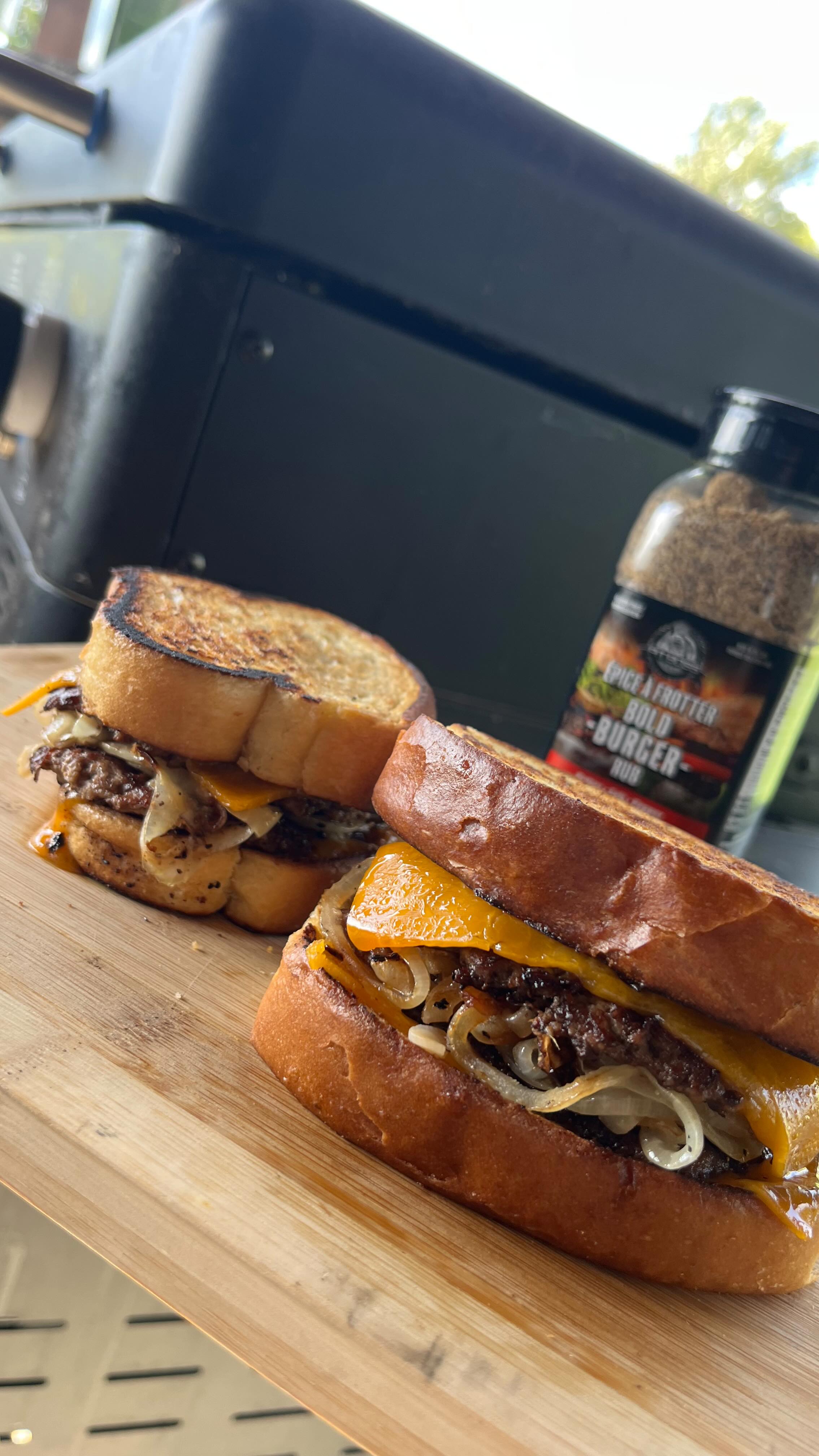 Instagram post by @fosterfeasts for Pit Boss Grills. Caption reads: Garlic bread double stacked smash burgers 🍔 with....