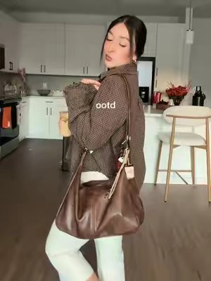 TikTok post by @_lilyedith_ for KKXIU Chain Store. Caption reads: just a girl in her fall vibes Bag @KKXIU US 🤎....