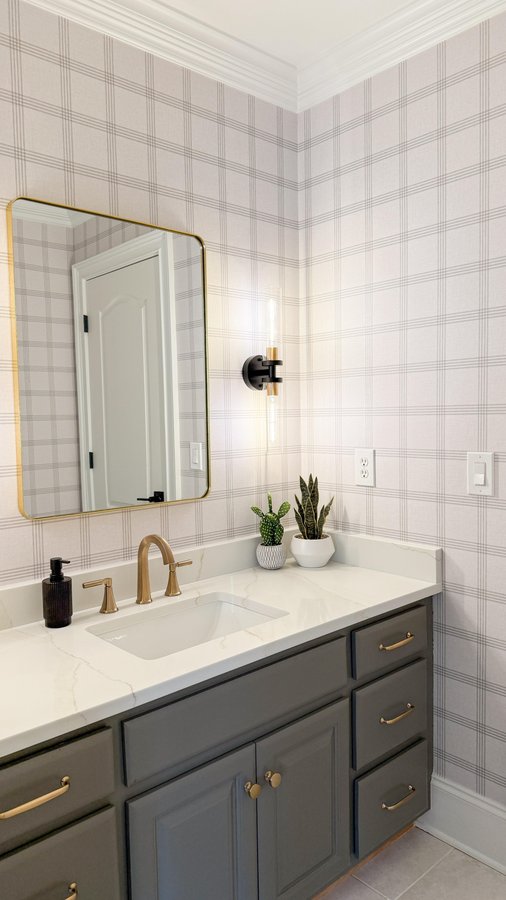 Instagram post by @wild.hearts.home for Delta Faucet. Caption reads: Bathroom renovations don’t have to be expensive,....