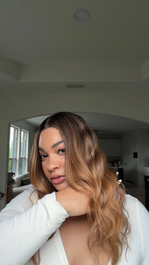 Instagram post by @iamlolaco for IGK Hair. Caption reads: [...] the Good Behavior Smoothing Spray from....