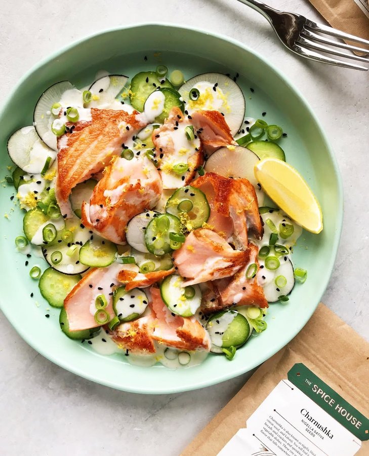 Instagram post by @foodminimalist for The Spice House. Caption reads: Pan-seared salmon salad with cucumbers and peppery....