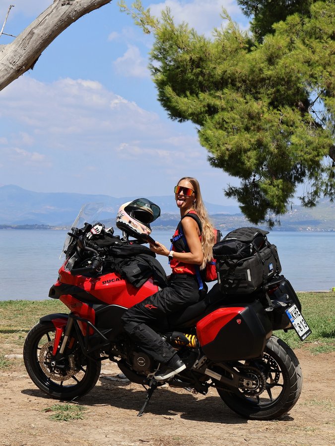 Instagram post by @dominika_rides for HJC Helmets. Caption reads: Nothing heals me like a road, a tent, and my....