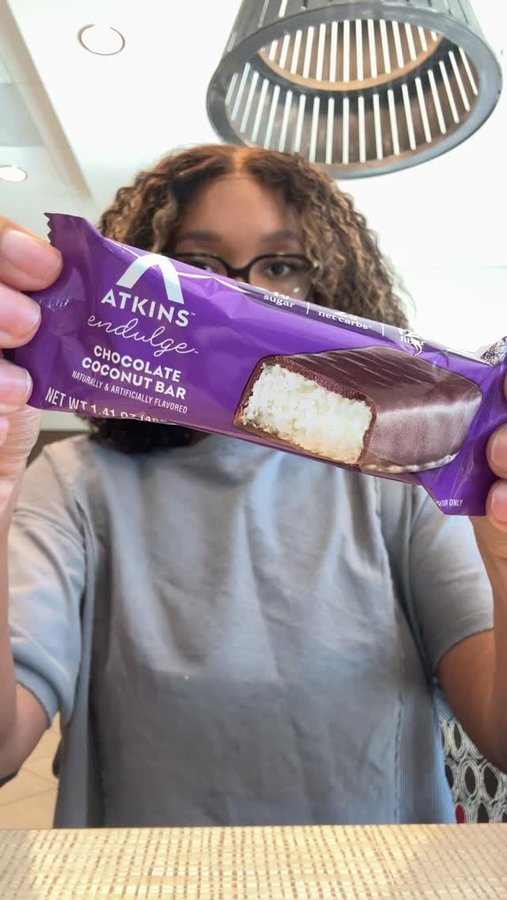 Instagram post by an influencer for Atkins. Caption reads: [...] cravings hit, I reach for the Atkins Endulge....