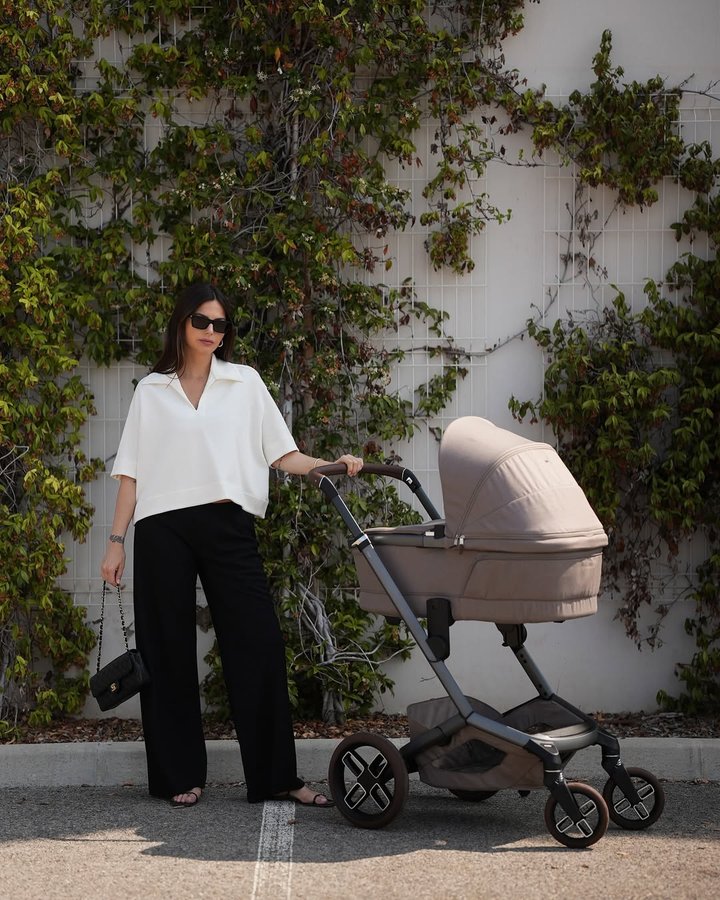 Instagram post by @kellypiquet for Maxi-Cosi. Caption reads: First strolls with Lily 💕 Grateful for slow....