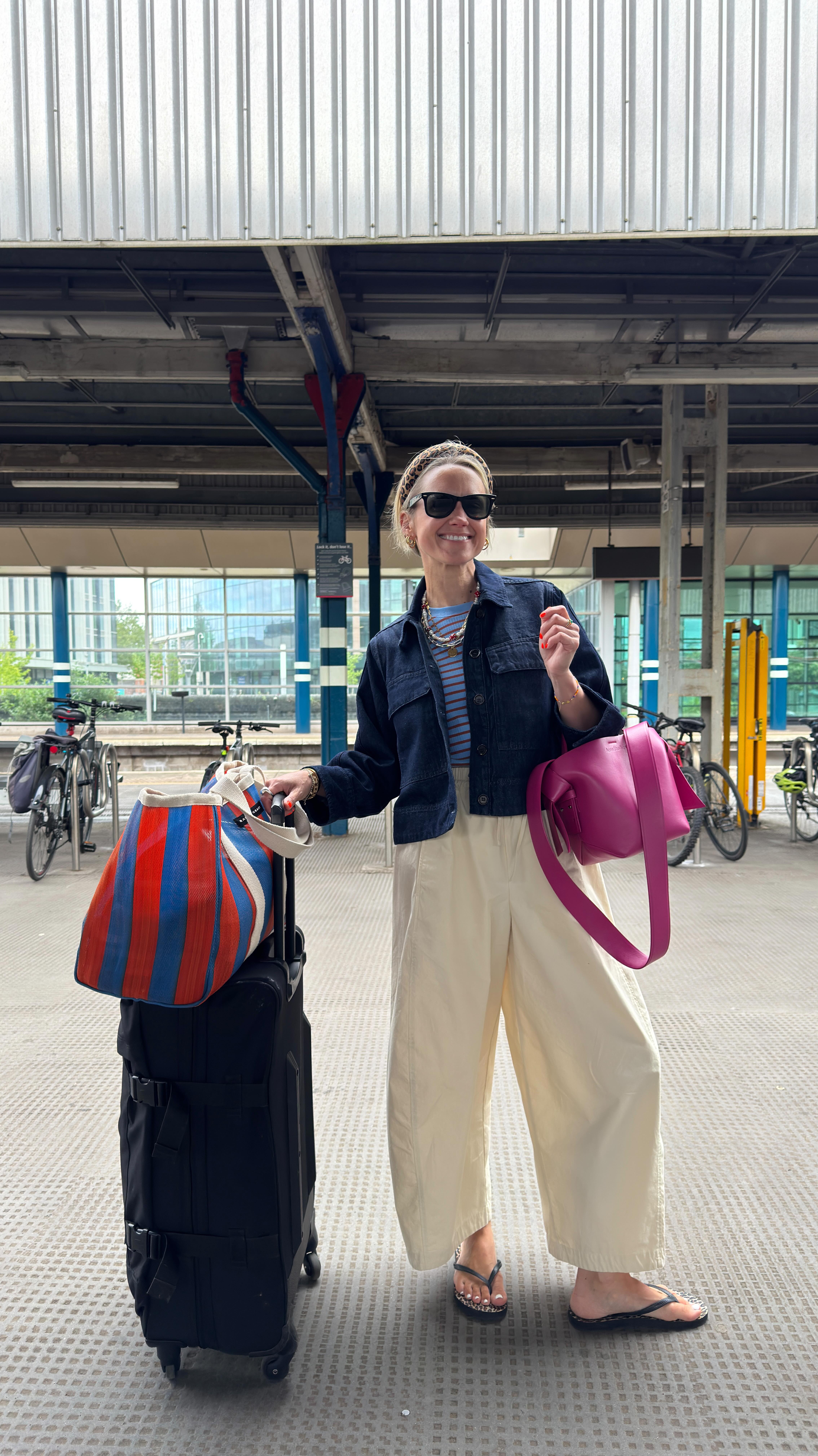 Instagram post by @goodmannersstyle for Eastpak. Caption reads: What I wore to travel to London Town 💛 always....