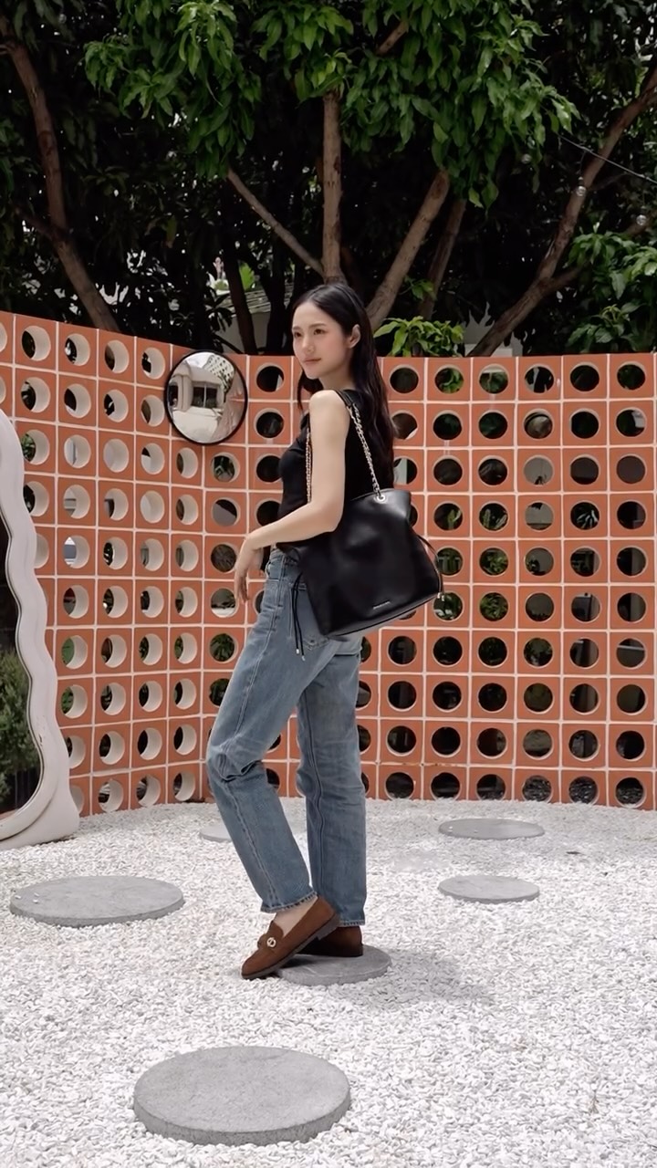 Instagram post by @lmlookmhee for CHARLES & KEITH Thailand. Caption reads: คุณลูกหมี @lmlookmhee แกะกล่องไอเทมใหม่สุดชิค 🤎....