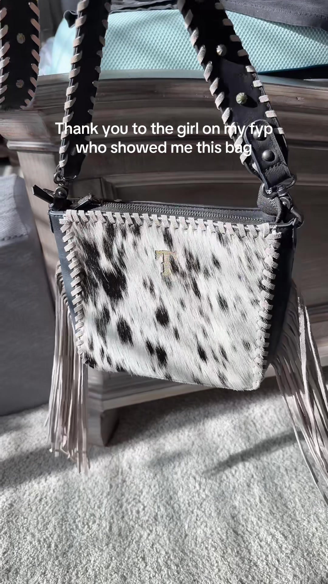 TikTok post by @cheyenne.wyoming for Vaqueras Outfitters. Caption reads: [...] crossbody from Trinity Ranch. @Vaqueras....