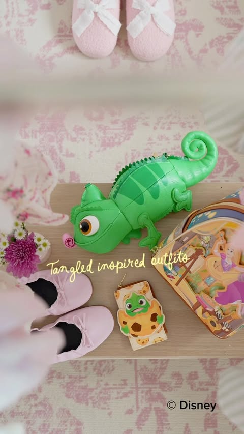 Instagram post by @dreamwithvalen for loungefly. Caption reads: [...] Tangled color palette: ✨🌸🦎☀️💜 ft.....