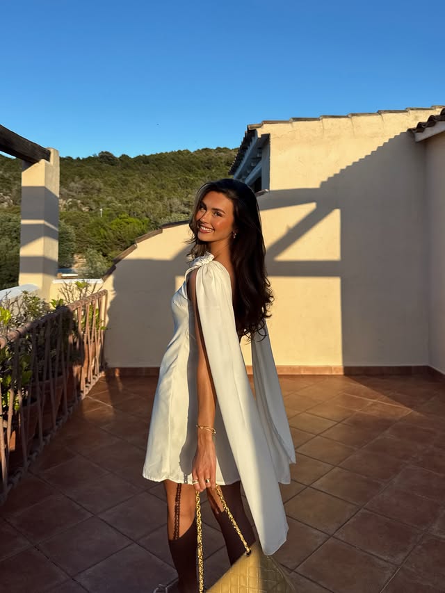 Instagram post by @amelie_weissenberger for NA-KD. Caption reads: [...] sunkissed 🌞 my dreamy dress is from....