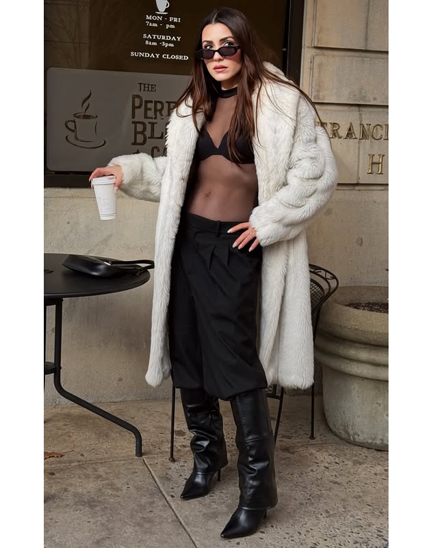 Instagram post by @silagunce for JustFab. Caption reads: [...] it. 🖤 Cozy layers. Powerful steps.....
