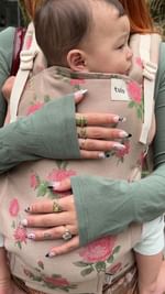 Instagram post by @yourgirlneens for Baby Tula. Caption reads: I ALWAYS get compliments on my @babytula....