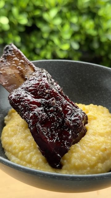 Instagram post by @castingandcookingbbq for Bespoke Post. Caption reads: [...] short ribs with creamy polenta!!....