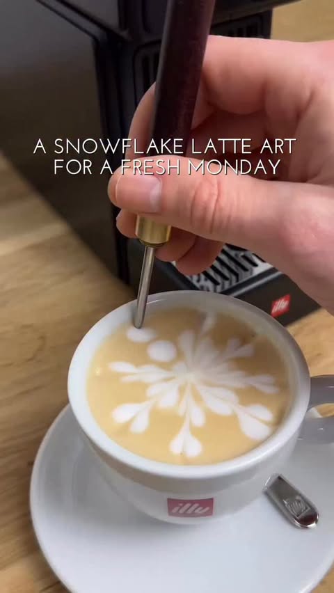 Instagram post by @baristahamburg for illy. Caption reads: [...] hands and a snowflake on your coffee....