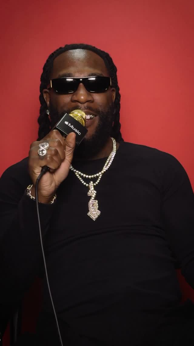 Instagram post by @burnaboygram for Apple Music. Caption reads: No Sign of Weakness. Mic Check with @burnaboygram....