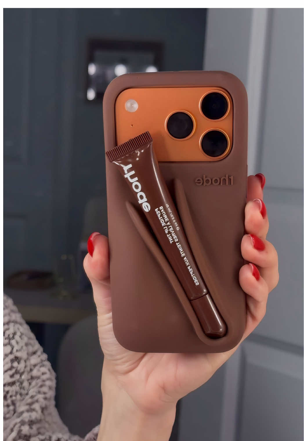 TikTok post by @emskins_ for Rhode. Caption reads: BACK IN STOCK 🔥 Rhode iPhone Case @RHODE #rhode....