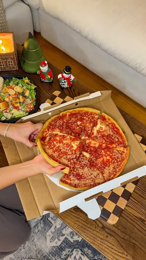 Instagram post by @thehangrylilbrunette for Lou Malnati's. Caption reads: When holiday cooking fatigue strikes, there’s only....