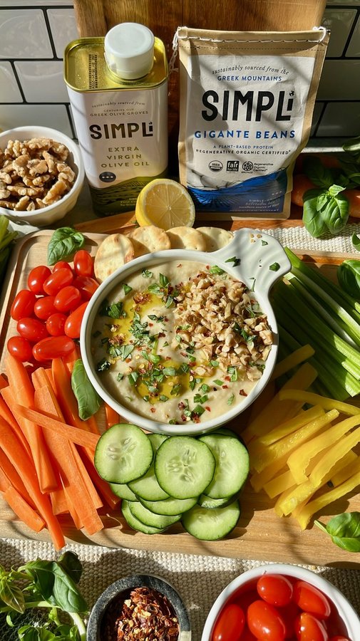 Instagram post by @walleats for SIMPLi. Caption reads: [...] ROASTED GARLIC BEAN DIP made with @eatsimpli....
