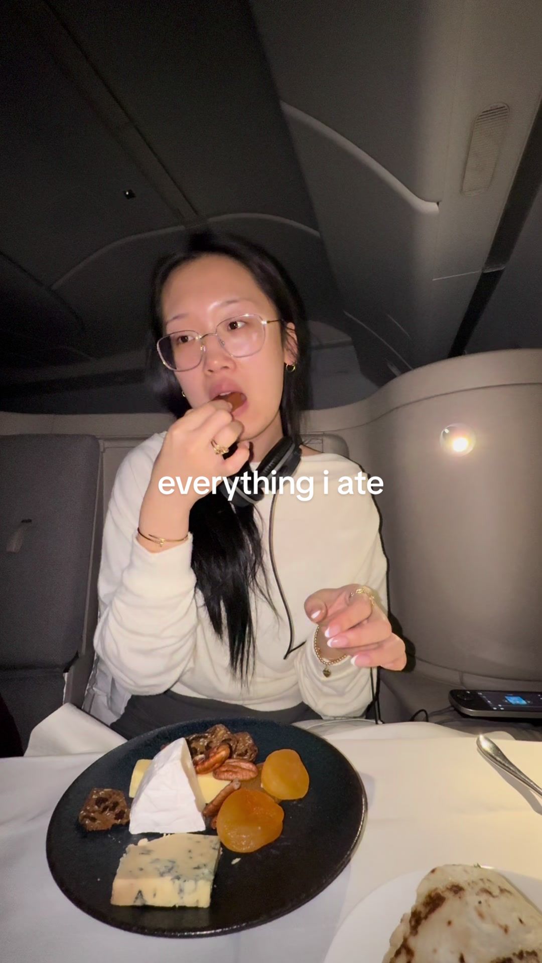 TikTok post by @via..li for Cathay Pacific. Caption reads: everything that i ate on my 16 hour flight to....