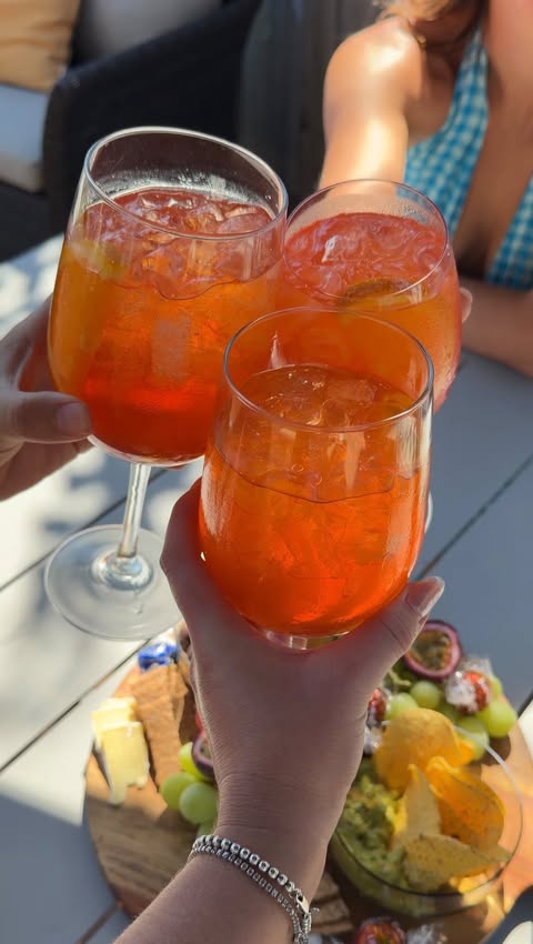 Instagram post by @liiiv.martin for Aperol Spritz. Caption reads: Who’s coming over for an Aperol Spritz?!? 😍🍊🥂....