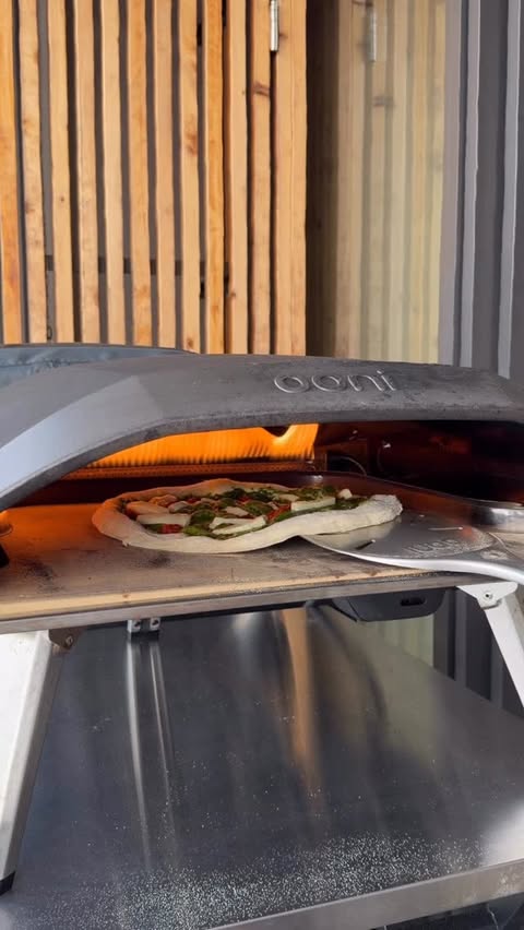 Instagram post by @7thfloorpizza for Ooni. Caption reads: [...] it bubbles. 🫣 Baked in the Ooni Koda 16. 🔥....