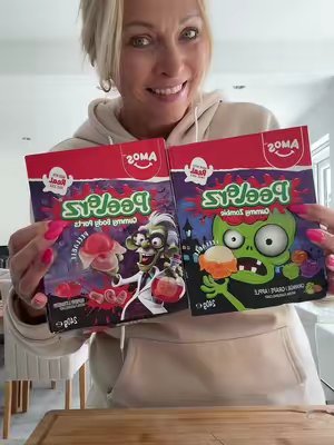 TikTok post by @wendyg_official for Amos Sweets. Caption reads: [...] peelable sweets for Halloween from @AMOS....