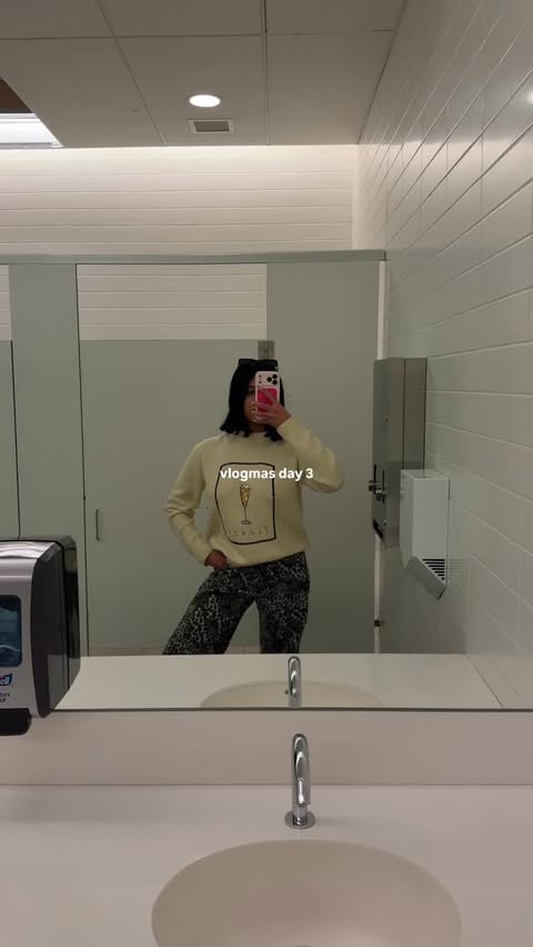 Instagram post by @thebarkhadiaries for Nasty Gal. Caption reads: vlogmas day 3 is HERE! another work christmas....