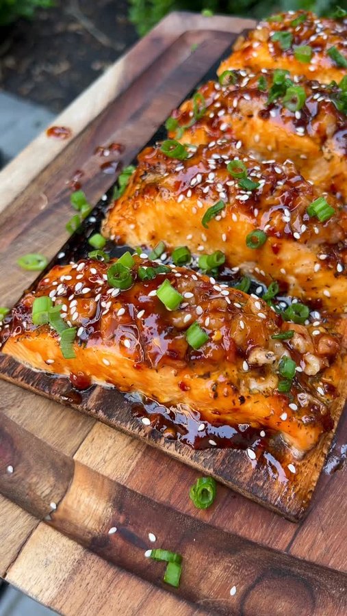 Instagram post by @bacusbbq for Kamado Joe. Caption reads: [...] salmon 🤤. 

Planked and cooked on my....