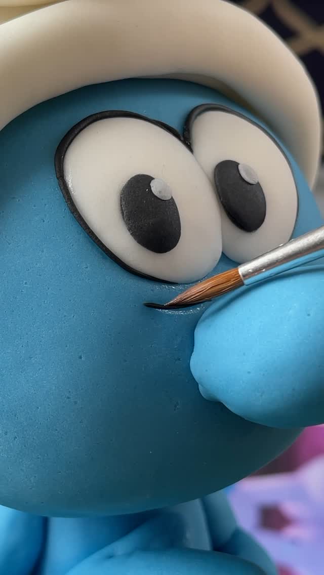 Instagram post by @zoesfancycakes for Paramount Pictures. Caption reads: #ad Our Smurf cake is bringing all the blue-tiful....