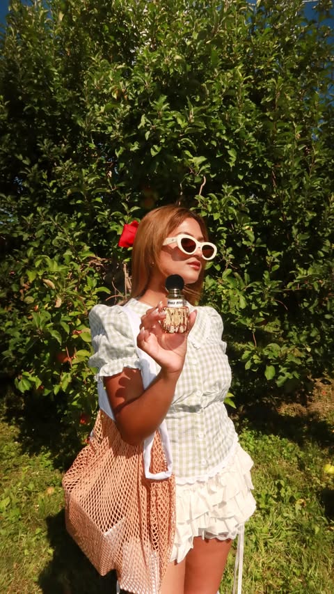 Instagram post by @annnie_eee for Miu Miu. Caption reads: [...] picking with 🍏🍎 🧺 Obsessed with my....