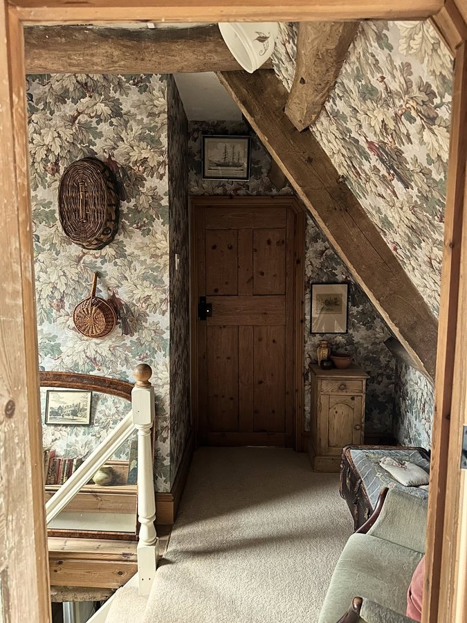 Instagram post by @harnhamhouse for Sandberg Wallpaper. Caption reads: The top floor landing decorated in the most....