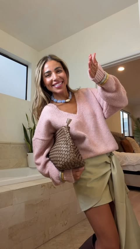 Instagram post by an influencer for REVOLVE. Caption reads: [...] Sweater: @lnaclothing Skirt: @revolve....