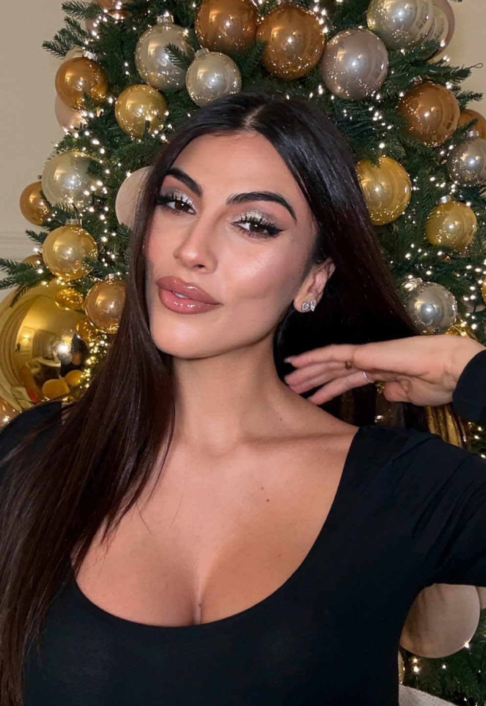 TikTok post by @giuliasalemiofficial for Overskin. Caption reads: Sparkling Holiday make up with @overskin 🪩🎄🩶 -....