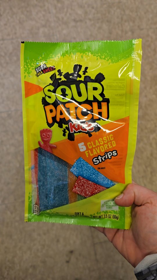 Instagram post by @foodiewiththebeasts for Sour Patch Kids. Caption reads: 👑 Sour Patch Kids Strips 👑

This is the candy of....