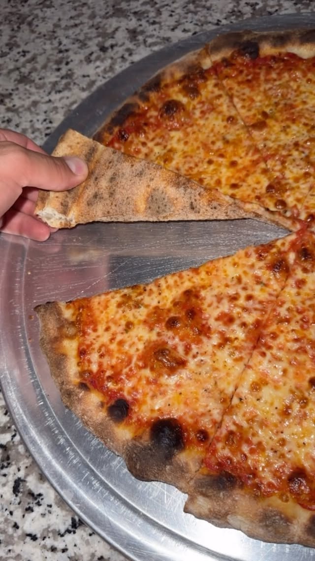 Instagram post by @ajeatworld for Baking Steel. Caption reads: [...] baked this pizza in my home oven on a....