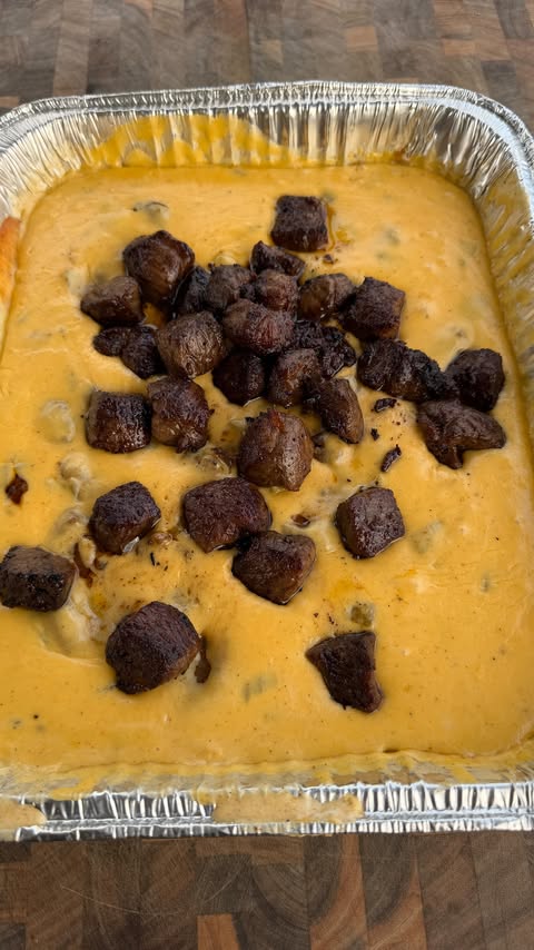Instagram post by @cooking_with_fire___ for Pit Boss Grills. Caption reads: [...] queso dip with steak bites on the....