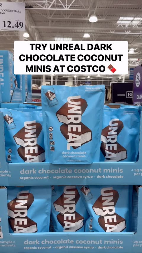 Instagram post by @costcobuys for UNREAL Snacks. Caption reads: 🍫 @unreal.snacks Dark Chocolate Coconut Minis....