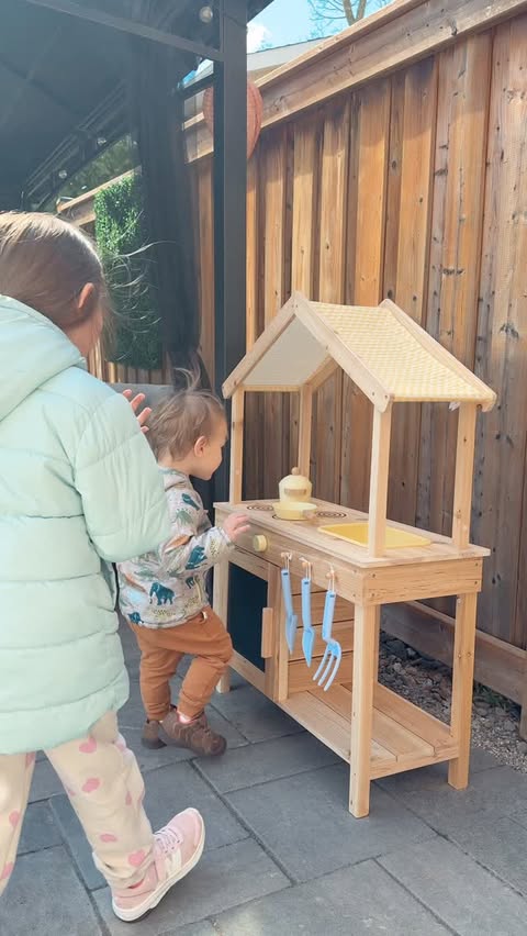 Instagram post by @ashleyvboni for Coco Village. Caption reads: [...] The Wooden Outdoor Play Kitchen from....