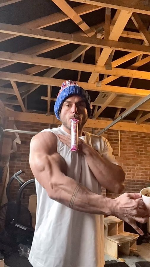 Instagram post by @rossedgley for PhD Nutrition. Caption reads: Tricep ‘sleeper build’ with @phdnutrition SmartBar....